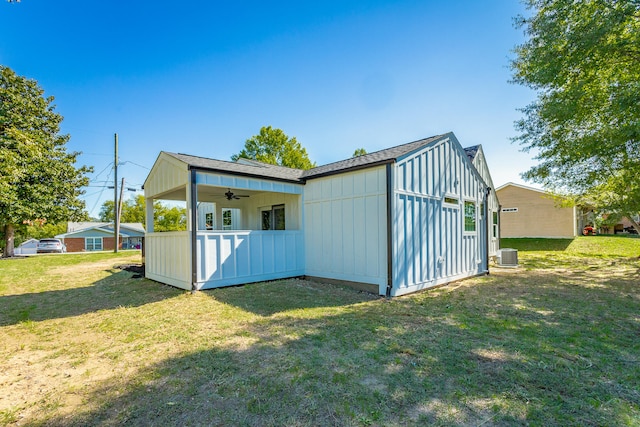 exterior space with ceiling fan, central AC unit, and a lawn