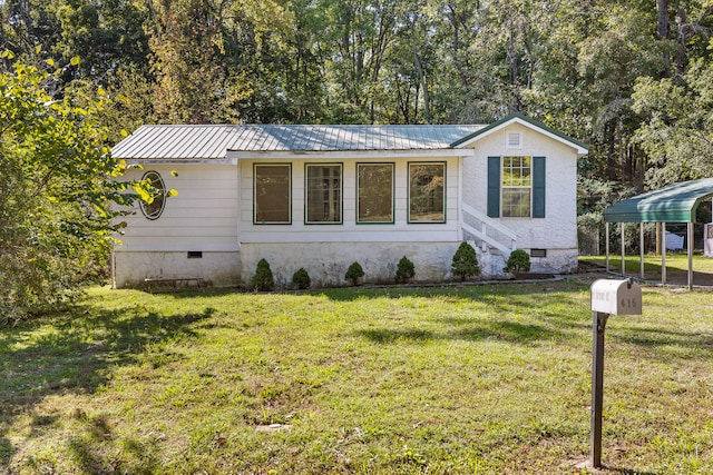 view of front facade with a carport and a front lawn