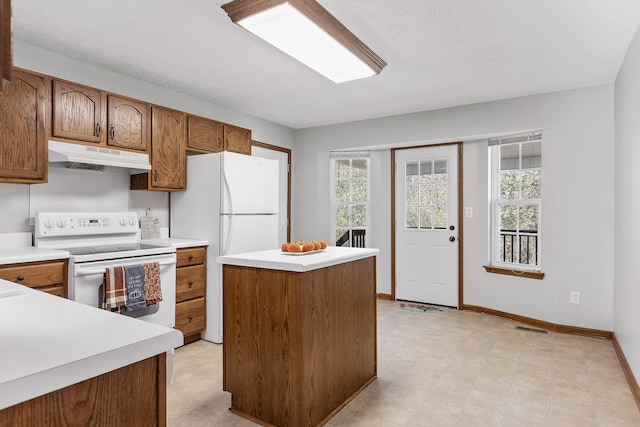 kitchen with a center island and white appliances