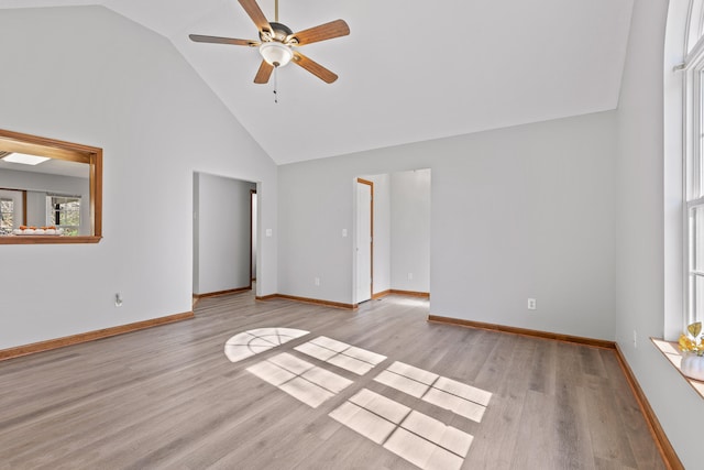 spare room with ceiling fan, light hardwood / wood-style floors, and high vaulted ceiling