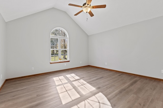 empty room featuring ceiling fan, light hardwood / wood-style floors, and lofted ceiling