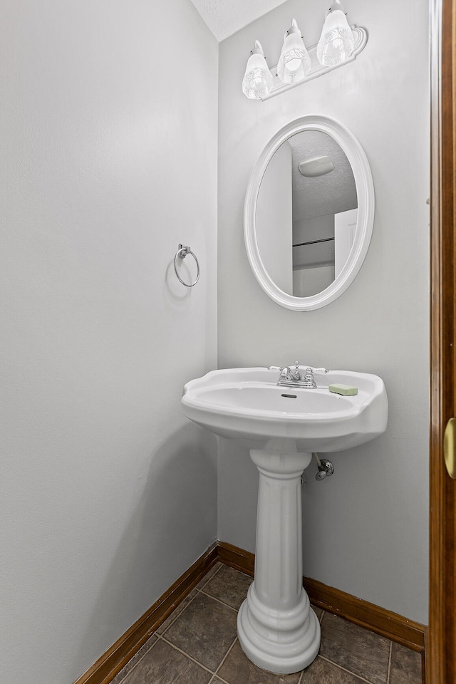 bathroom featuring tile patterned flooring and a textured ceiling