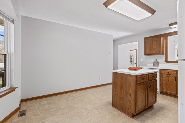 kitchen featuring a textured ceiling and a kitchen island