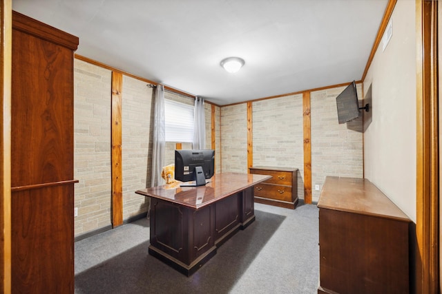 carpeted home office with brick wall