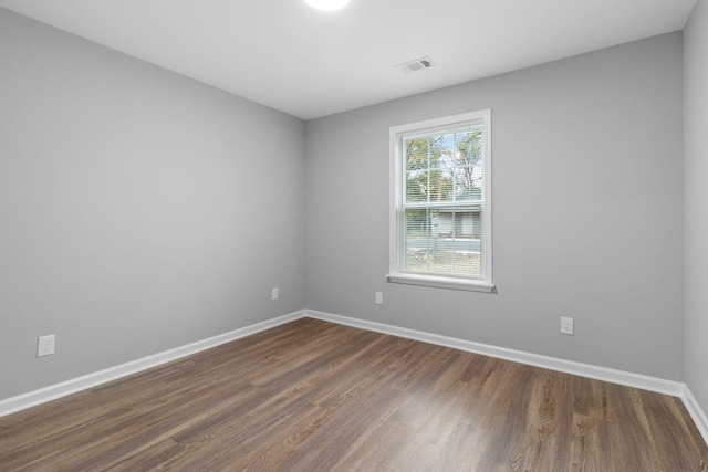 spare room featuring dark hardwood / wood-style floors