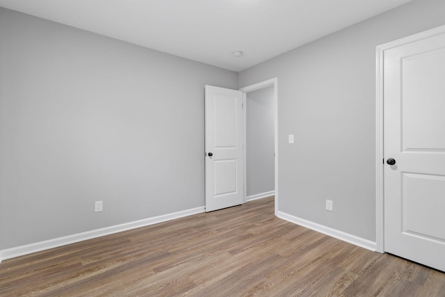 unfurnished room with light hardwood / wood-style floors