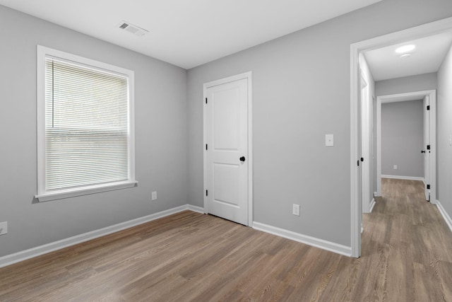 unfurnished bedroom featuring hardwood / wood-style floors