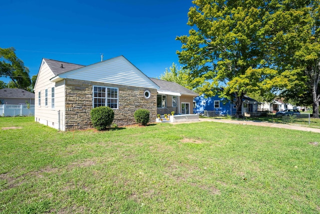 rear view of house featuring a yard