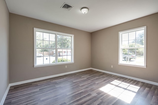 spare room with dark hardwood / wood-style flooring