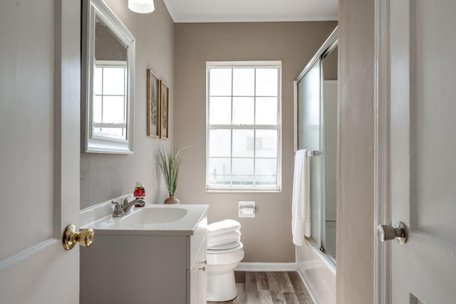 full bathroom with wood-type flooring, vanity, toilet, and a wealth of natural light