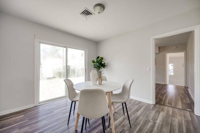 dining area with dark hardwood / wood-style floors