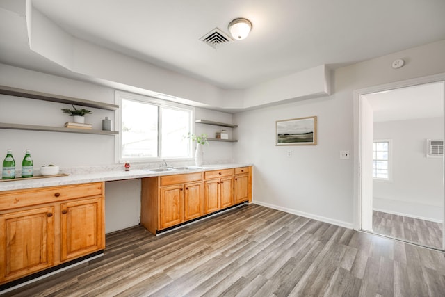 kitchen with sink, dark hardwood / wood-style flooring, and a healthy amount of sunlight