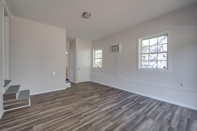 unfurnished room featuring dark hardwood / wood-style floors and a healthy amount of sunlight