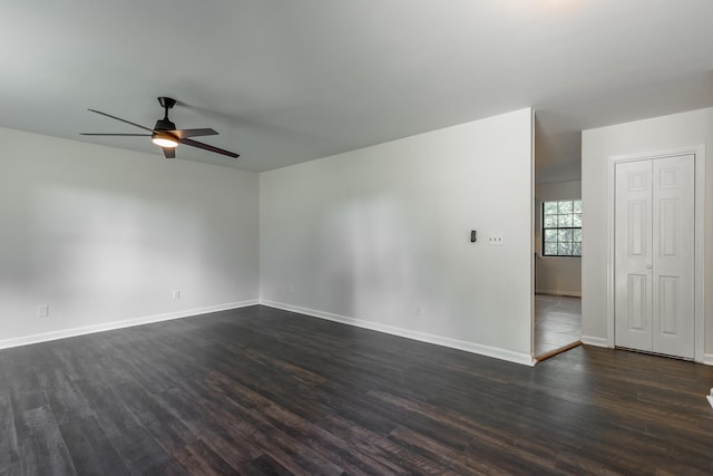 spare room featuring dark hardwood / wood-style flooring and ceiling fan