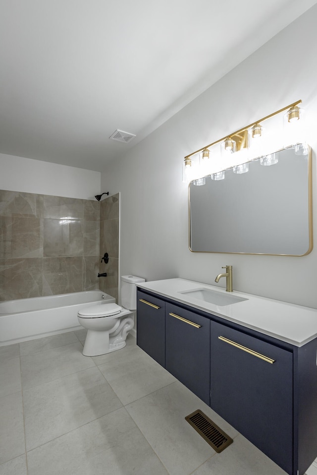 full bathroom featuring vanity, tile patterned flooring, toilet, and tiled shower / bath