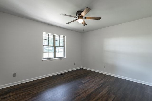 empty room featuring ceiling fan and dark hardwood / wood-style flooring