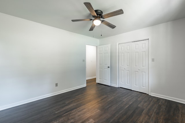 unfurnished bedroom with ceiling fan, a closet, and dark hardwood / wood-style floors