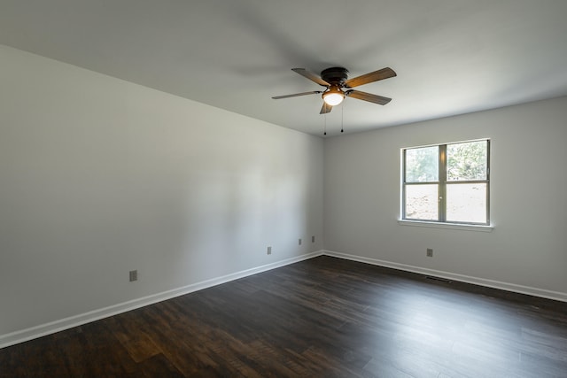 empty room with ceiling fan and dark wood-type flooring