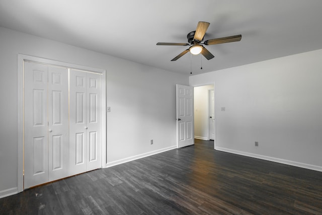 unfurnished bedroom with dark wood-type flooring, a closet, and ceiling fan