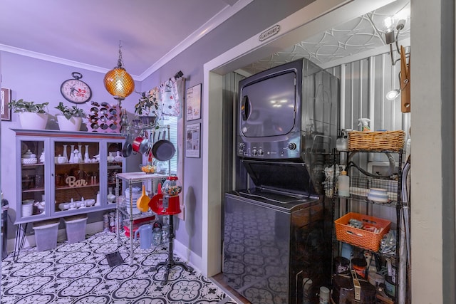 laundry room featuring crown molding and stacked washer and clothes dryer