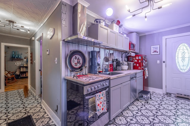 kitchen featuring sink, crown molding, appliances with stainless steel finishes, and wall chimney range hood