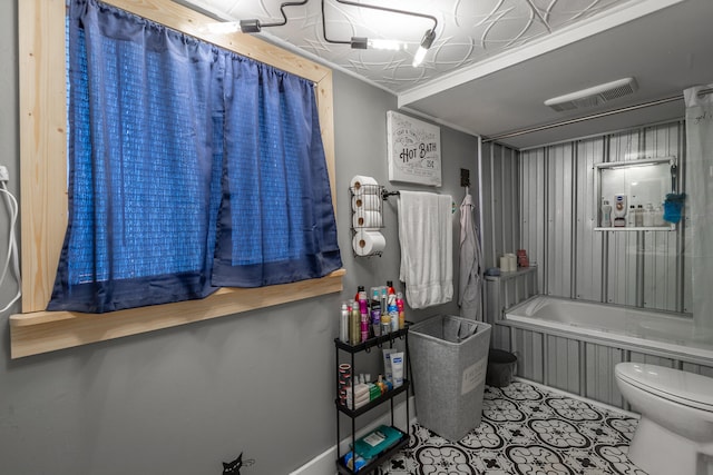 bathroom featuring toilet and a tub