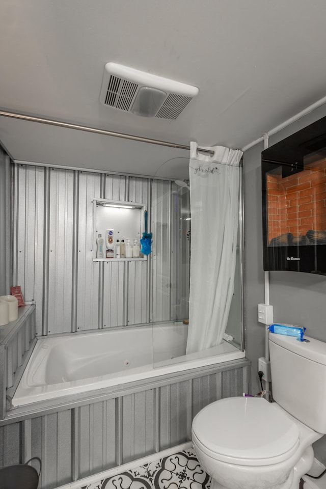 bathroom with toilet and tile patterned flooring