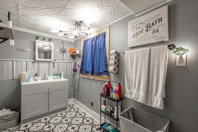 bathroom featuring vanity and ornamental molding