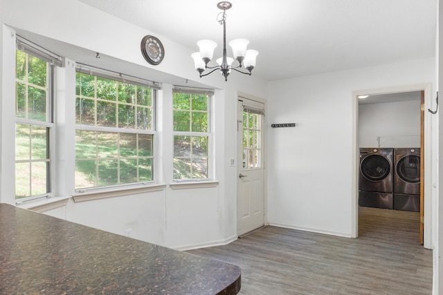 doorway featuring hardwood / wood-style flooring, a healthy amount of sunlight, and independent washer and dryer