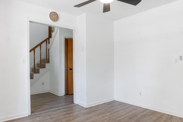 empty room with ceiling fan and hardwood / wood-style flooring