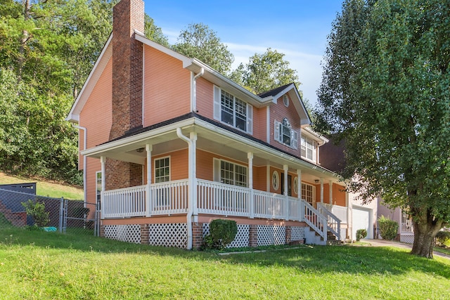 exterior space featuring a yard, a garage, and a porch