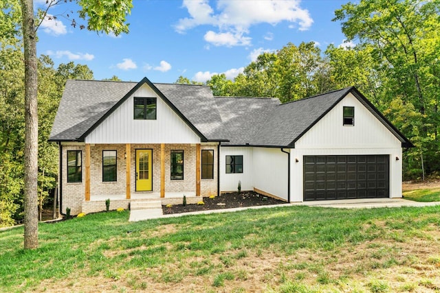 modern inspired farmhouse featuring a front yard and a garage