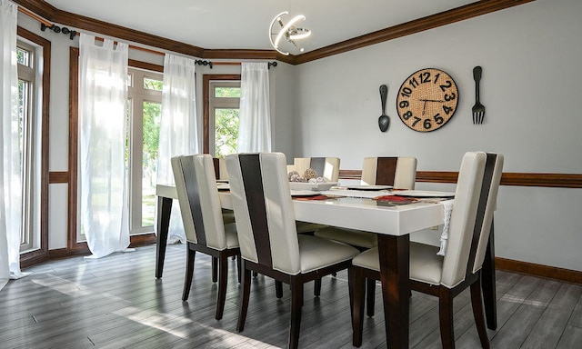 dining area featuring ornamental molding, an inviting chandelier, and wood-type flooring