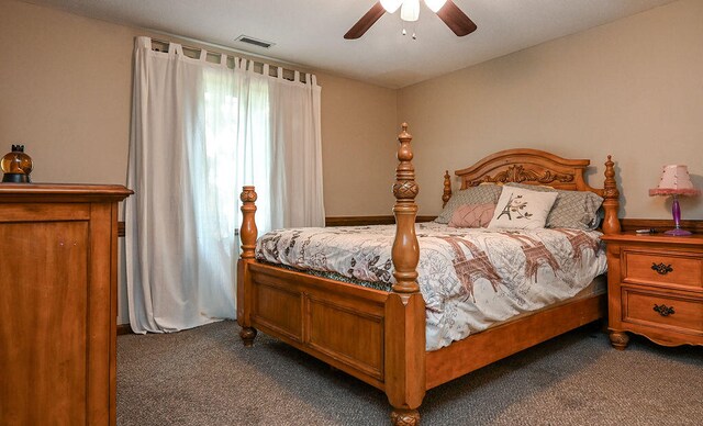 bedroom featuring ceiling fan and dark carpet