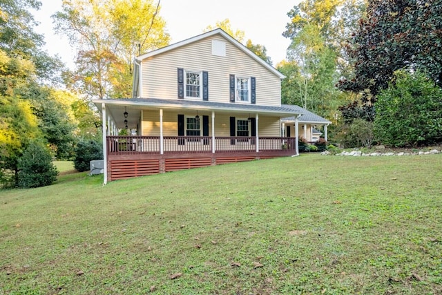 country-style home with a front lawn and covered porch