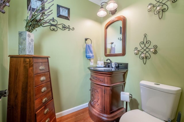 bathroom featuring hardwood / wood-style flooring, vanity, and toilet