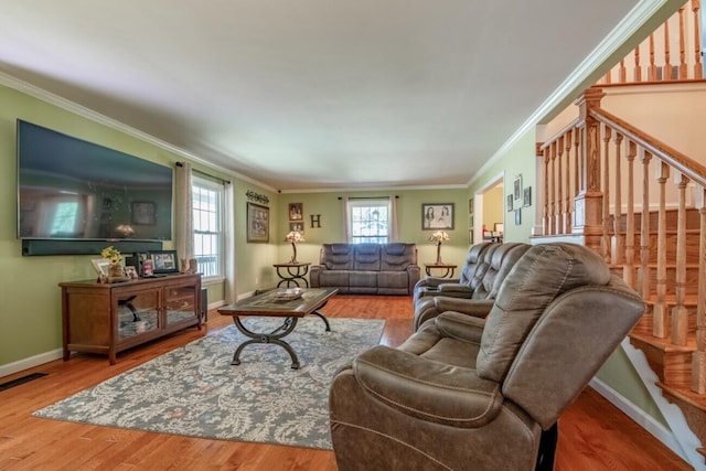 living room with crown molding and hardwood / wood-style floors