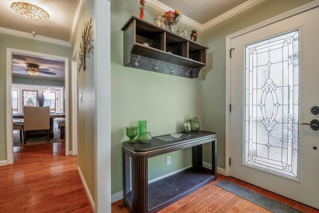 interior space with wood-type flooring, crown molding, and ceiling fan