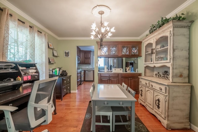 kitchen with plenty of natural light, light hardwood / wood-style floors, a chandelier, and hanging light fixtures