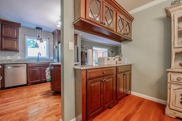 kitchen with decorative light fixtures, dishwasher, light hardwood / wood-style flooring, and crown molding