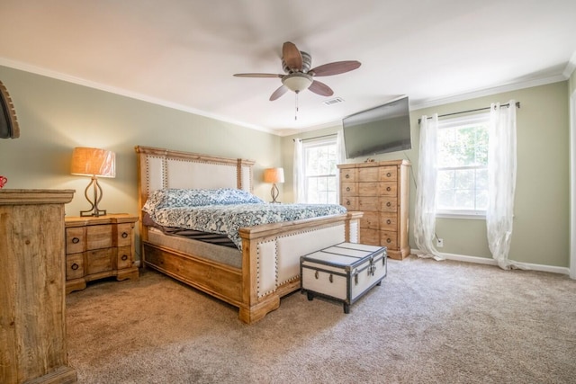 bedroom featuring ornamental molding, multiple windows, ceiling fan, and carpet