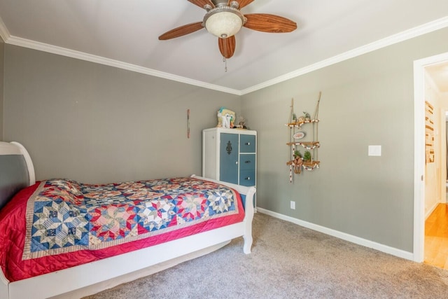 carpeted bedroom featuring ceiling fan and crown molding