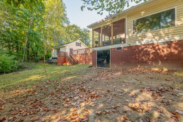 view of yard with a wooden deck and a sunroom