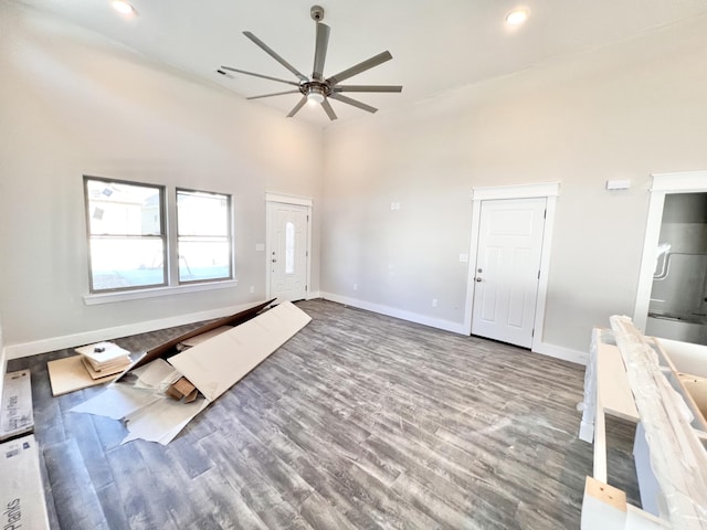 unfurnished living room featuring hardwood / wood-style flooring and ceiling fan