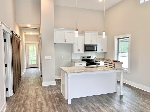 60 Ables Way, Ringgold, GA 30736 - kitchen with stainless steel appliances, high vaulted ceiling, baseboards, white cabinets, and dark wood finished floors