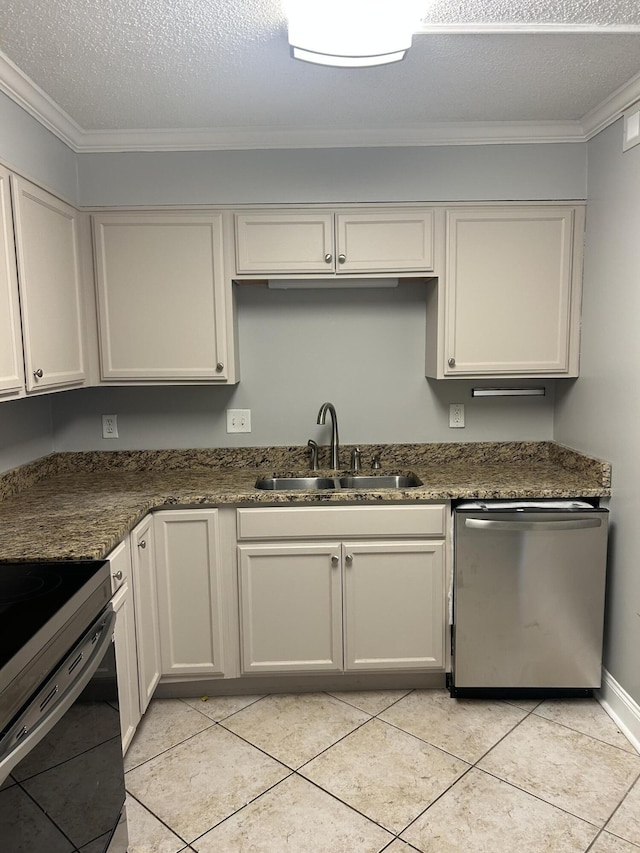 kitchen featuring dark stone counters, white cabinets, and stainless steel appliances