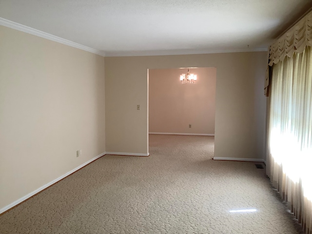 carpeted empty room featuring ornamental molding, an inviting chandelier, and a textured ceiling