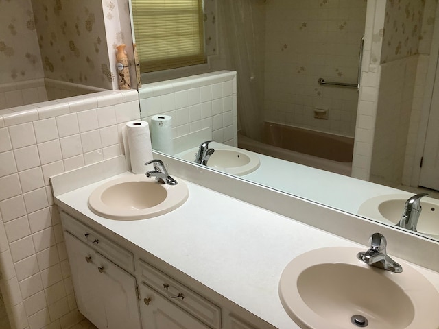 bathroom featuring shower / tub combo, vanity, and tile walls