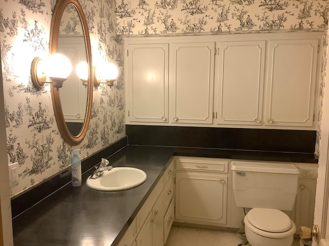 bathroom featuring vanity and toilet