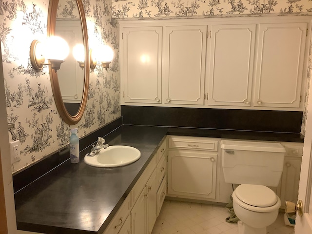 bathroom featuring vanity, toilet, and tile patterned floors